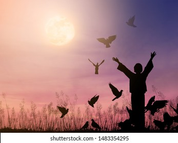 Alone woman praying and free bird flying to the dramatic sky background, hope and peace concept. - Shutterstock ID 1483354295