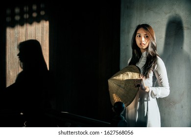 Alone woman wearing Ao Dai is Vietnam traditional dress in the old house France style