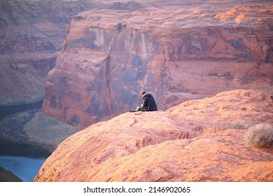 Alone,sitting On The Grand Canyon Horseshoe Bend.