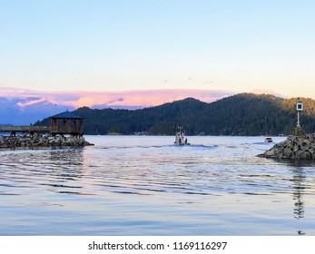 along the Sunshine Coast. Water is calm and tranquil., Boats leaving the harbour as the sun goes down in Gibsons, british columbia