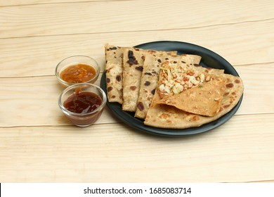 Aloo Gobi Paratha Served In Black Dish On Wooden Background