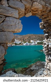 Alopronoia harbor through an arch, in Sikinos island, Cyclades, Greece