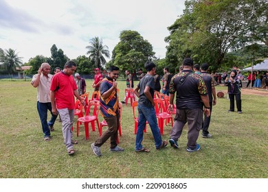 Alor Setar, Kedah, Malaysia - September 20th, 2022 : Group Of People  Men, Women And Kid  Playing Musical Chair Game