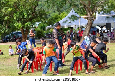 Alor Setar, Kedah, Malaysia - September 20th, 2022 : Group Of People  Men, Women And Kid  Playing Musical Chair Game