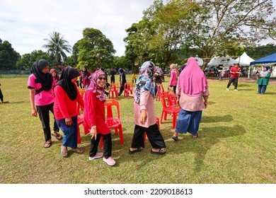 Alor Setar, Kedah, Malaysia - September 20th, 2022 : Group Of People  Men, Women And Kid  Playing Musical Chair Game