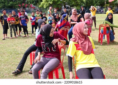 Alor Setar, Kedah, Malaysia - September 20th, 2022 : Group Of People  Men, Women And Kid  Playing Musical Chair Game