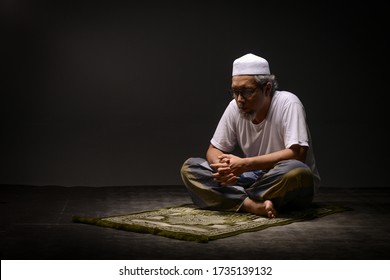 Alor Setar, Kedah - May 15,2020. Muslim man perform a pray.Concept photoshoot in a studio with black background.