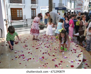 Alora, Spain - May 11, 2007: Children Picking Confetti Off Church Steps After Wedding