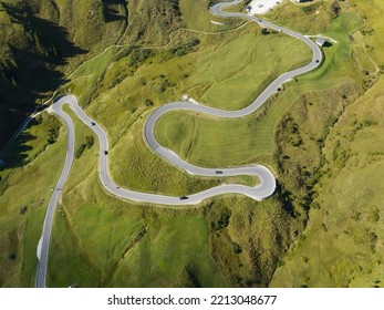 Alp adventure road hair pin twisty in the Dolomites, Italy. Aerial drone overview. Driving route rally cars and traffic passing over a mountain range. Overhead. - Powered by Shutterstock