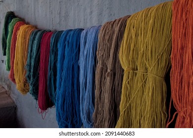 Alpaca llama wool yarn that has been dyed using traditional natural methods by andean indigenous people in peru for toursits to buy textile.