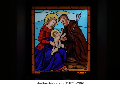 Alpe Devero, Italy - June 30 2022: Colorful Stained Glass Window Icon  Of Jesus Christ, Mary And Joseph In Oratory Of San Bartolomeo, Alpe Devero, Lepontine Alps, Ossola, Piedmont, Italy