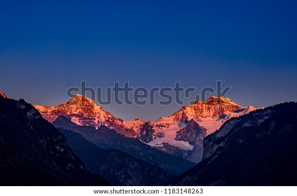 Alpenglow, the mountains Mönch and Jungfrau in the\
Bernese Alps, Bernese Oberland, Interlaken, Canton Bern,\
Switzerland, Europe