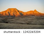 Alpenglow on badlands mountain cliffs in Eastern Montana during sunrise, near Miles City, MT