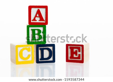 Alphabet ABCDE blocks on white background.