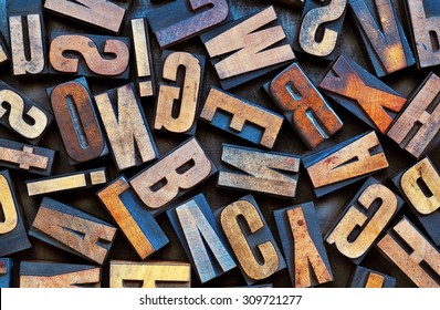 alphabet background - vintage letterpress wood printing blocks placed randomly on a grunge metal tray - Shutterstock ID 309721277