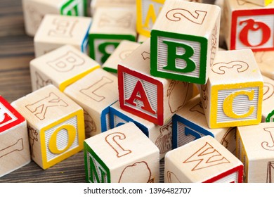 Alphabet blocks ABC on wooden table.