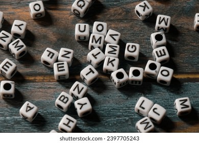 Premium Photo  Cubes beads letters alphabet / background of wooden cubes  with alphabet letters, concept education reading, learning letters