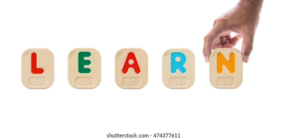 Alphabet blocks spelling the word LEARN with Braille and hand holding N - Powered by Shutterstock