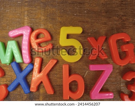 Alphabet educations abcd for kids. spelling from plastic letter on wooden background