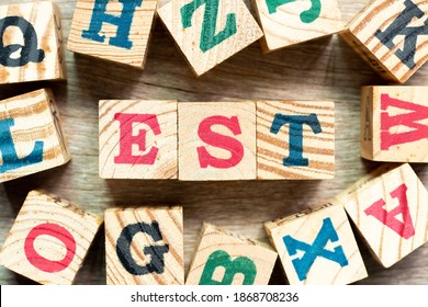 Alphabet Letter Block In Word (abbreviation Of Established, Estimated, Eastern Time Zone, Expressed Sequence Tag) With Another On Wood Background