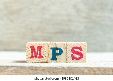 Alphabet Letter Block In Word MPS (Abbreviation Of Master Production Schedule Or Mucopolysaccharidosis) On Wood Background