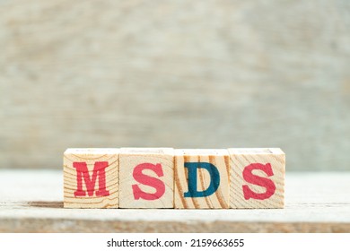 Alphabet Letter Block In Word MSDS (Abbreviation Of Material Safety Data Sheet) On Wood Background