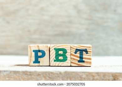 Alphabet Letter Block In Word PBT (Abbreviation Of Profit Before Tax) On Wood Background