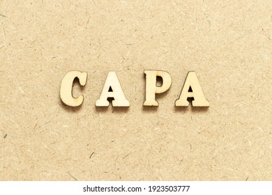 Alphabet letter in word CAPA (abbreviation of corrective action and preventive action) on wood background
