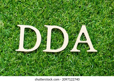 Alphabet letter in word DDA (Abbreviation of Depreciation, depletion and amortization or demand deposit account) on green grass background