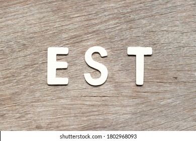 Alphabet Letter In Word  Est (abbreviation Of Established, Estimated, Eastern Time Zone, Expressed Sequence Tag) On Wood Background