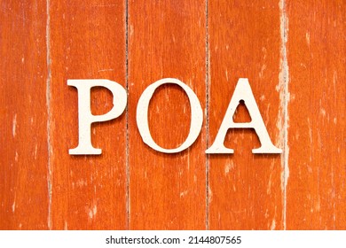 Alphabet Letter In Word POA (Abbreviation Of Plan Of Action, Power Of Attorney, Period Of Availability Or Paid On Arrival) On Old Red Color Wood Plate Background