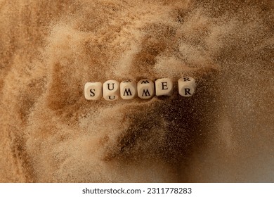 Alphabet letter wording "Summer" bead toy flying over sand explosion flying in air. Summer word alphabet letter show tropical island beach sand for vacation holiday. Top view action - Shutterstock ID 2311778283