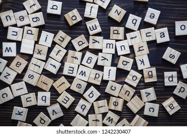 Alphabet letters on wooden scrabble pieces, from above