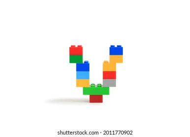Alphabet letters V from colorful plastic brick block constructor isolated on white background. Image with Clipping path