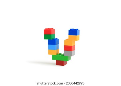 Alphabet letters V from colorful plastic brick block constructor isolated on white background. Image with Clipping path