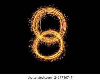 Alphabet and Number eight sparklers on black background by light painting.number 8 sparkling golden for party and Celebrate.