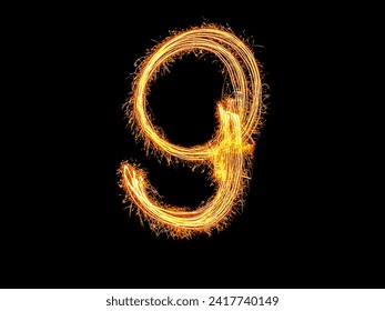 Alphabet and Number nine sparklers on black background by light painting.number 9 sparkling golden for party and Celebrate.