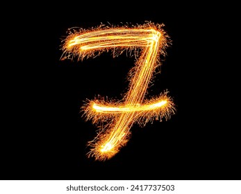 Alphabet and Number seven sparklers on black background by light painting.number 7 sparkling golden for party and Celebrate.
