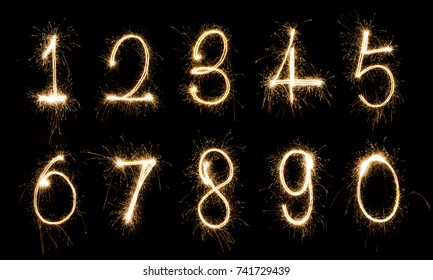 Alphabet And Numbers Sparklers On Black Background