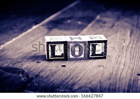 alphabet wood blocks forming the word lol.  Vintage process.