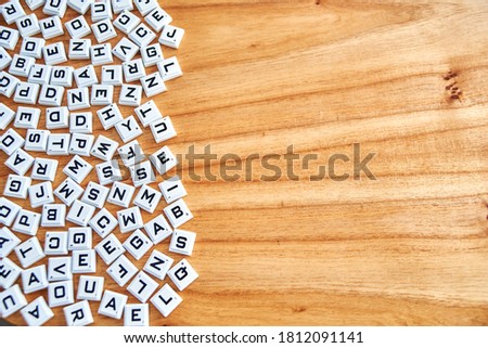Alphabets concept random on a wooden background