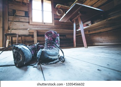 Alpine boots inside of a rustic mountain chalet, Austria