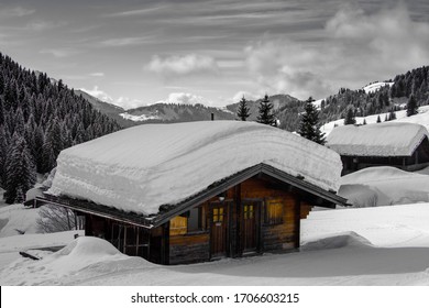 Alpine chalet under a thick layer of snow