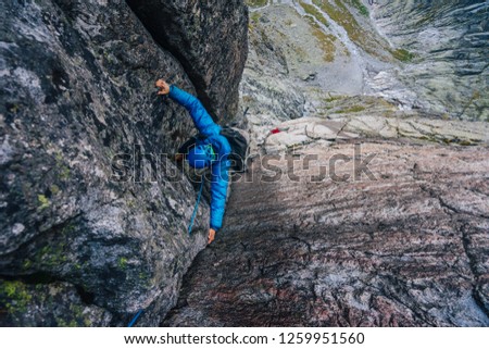 Alpine climbing adventure. A climber or an alpinist ascending big wall in High Tatras, Slovakia. Climbing on granit, Kezmarsky stit. A big wall climber in rock wall. Multipitch climbing, extreme sport
