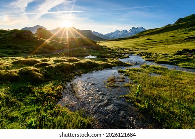 alpine creek at sunrise with peak of Titlis near Melchseefrutt in the swiss alps - Shutterstock ID 2026121684