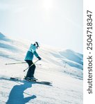 Alpine Downhill Skiing. Ski portrait of woman alpine skier wearing skis, helmet, cool ski goggles and blue elegant winter jacket and ski gloves on freezing cold day in winter