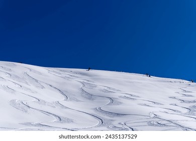Alpine freeride skier doing turns in deep snow at Klingenstock mountain at Stoos on a sunny winter day. Photo taken February 13th, 2024, Klingenstock, Stoos, Canton Schwyz, Switzerland.