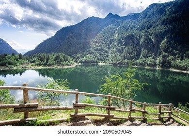 Alpine high mountain lake, coniferous woods are reflected in the water, Antrona valley Campliccioli lake, Italy Piedmont