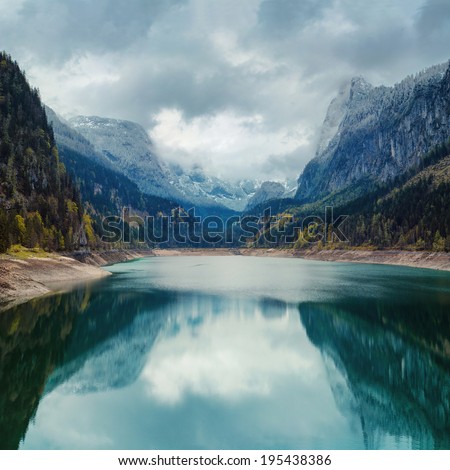 Alpine lake with dramatic sky and mountains. UNESCO heritage site. Gosausee, Tirol, Austria 