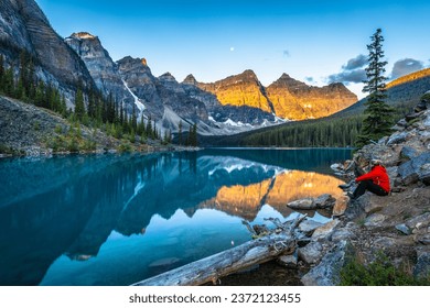 Alpine lake in mountains at sunrise. Moraine Lake in Banff National Park, Canadian Rockies, Alberta, Canada.